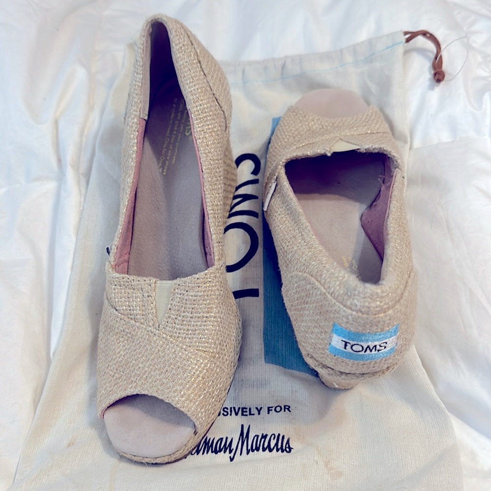 Women’s wedge TOMS shoes. Little discoloration on inside of left foot. Worn once